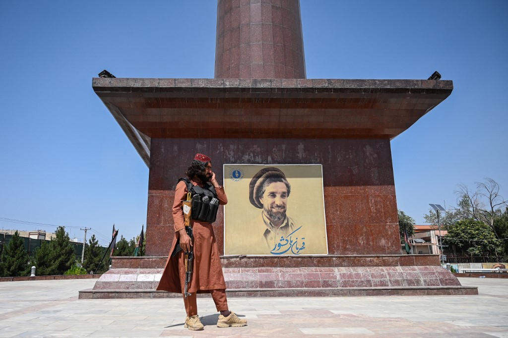 A Taliban fighter stand next to poster bearing the image late Afghan commander Ahmad Shah Massoud at the Massoud Square in Kabul on August 16, 2021. u00e2u20acu201d AFP pic