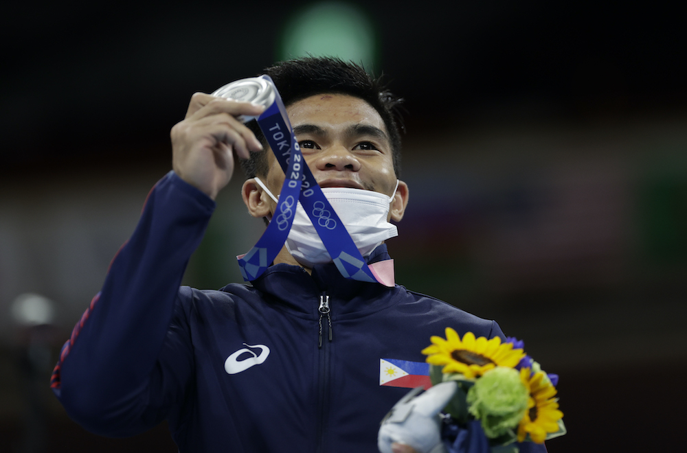 Silver medallist Carlo Paalam of the Philippines poses for photos during the medal ceremony for the Menu00e2u20acu2122s Flyweight at the Kokugikan Arena in Tokyo, August 7, 2021. u00e2u20acu201d Reuters picnnnn