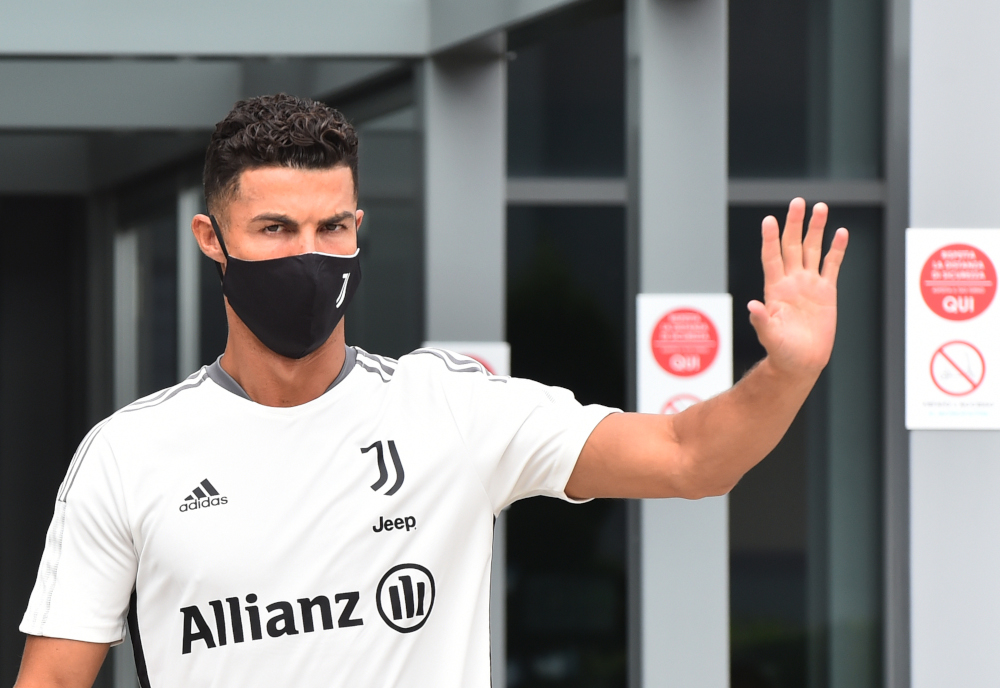 Juventusu00e2u20acu2122 Cristiano Ronaldo wearing a protective face mask waves as he leaves Juventus medical centre in Turin, July 26, 2021. u00e2u20acu2022 Reuters pic 