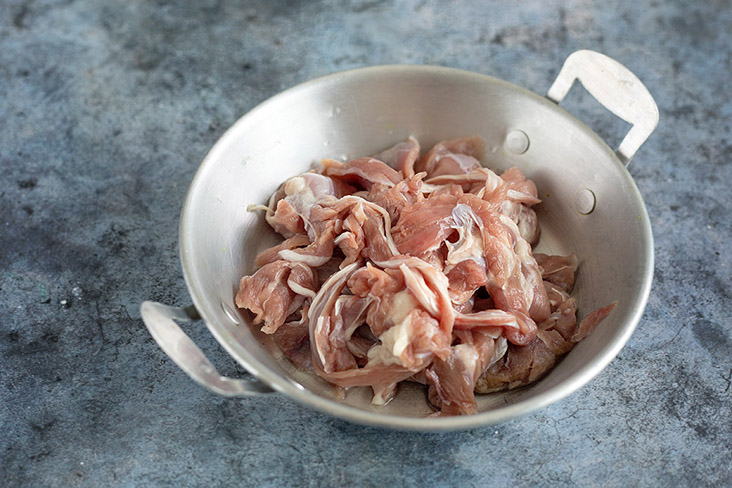 Blanch the pieces of duck meat before sautéing with sesame oil and smashed ginger.