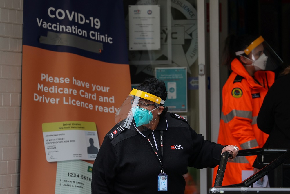 A staff member works at the front entrance of a Covid-19 vaccination clinic in the Bankstown suburb in Sydney, Australia August 25, 2021. u00e2u20acu2022 Reuters pic