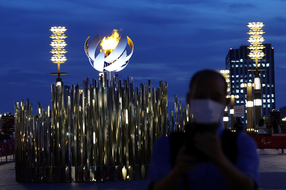 A man wearing a protective mask stands in front of the second Paralympic flame cauldron at Ariake Yume-no-Ohashi Bridge, a day after the official opening of Tokyo 2020 Paralympic Games, in Tokyo August 25, 2021. u00e2u20acu2022 Reuters pic