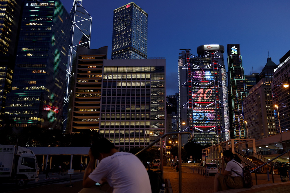 People rest in front of skyscrapers at the central business district, including China Construction Bank  Tower, Bank of China Tower, Cheung Kong Centre, HSBC and Standard Chartered Bank headquarters, in Hog Kong, China August 17, 2021. u00e2u20acu2022 Reuters picnn