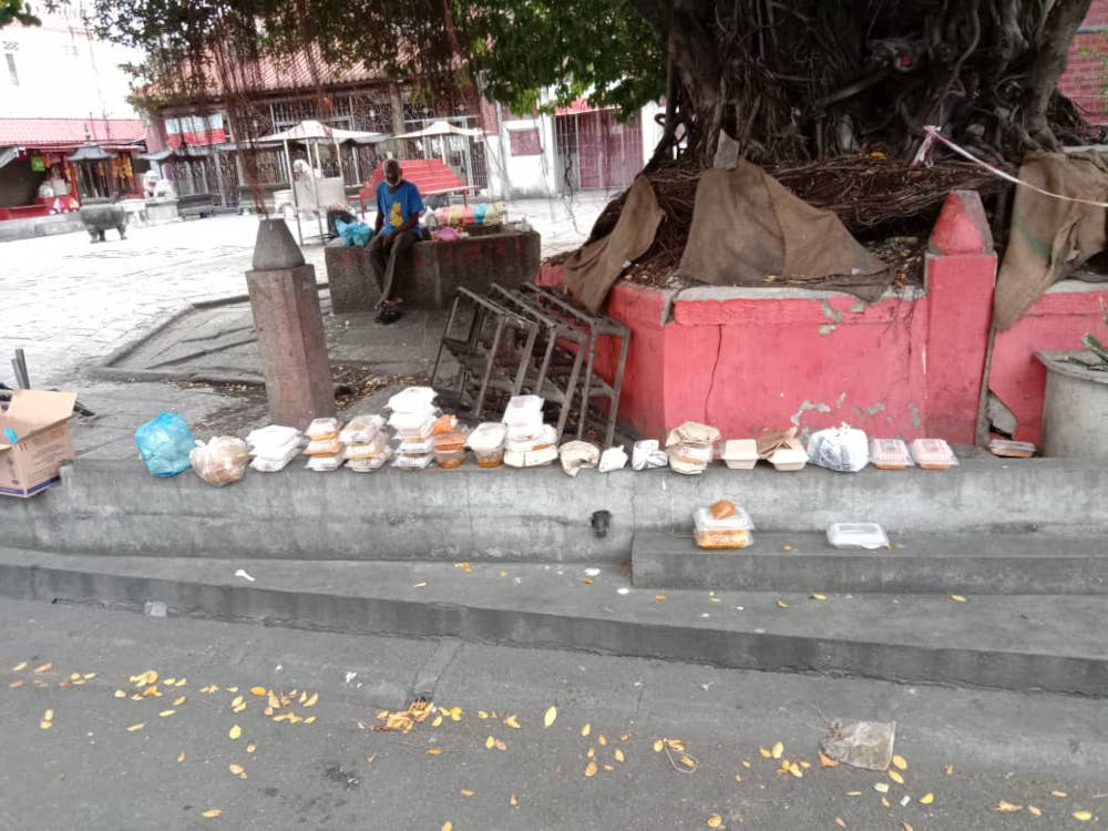 Packets of food distributed to the poor were left by the roadside, August 8, 2021. u00e2u20acu2022 Picture courtesy of Penang Hindu Association.