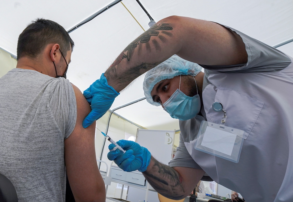 A migrant worker receives a jab while being injected with the one-dose Sputnik Light vaccine against the Covid-19 in a vaccination centre at a city market in Moscow, Russia, June 30, 2021. u00e2u20acu201d Reuters picnn
