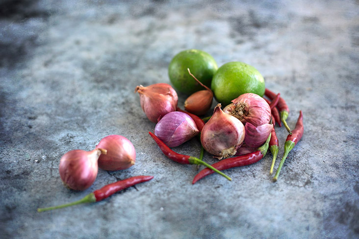A trio of pungency, acid and heat: red onions, fresh limes and 'cili padi.'