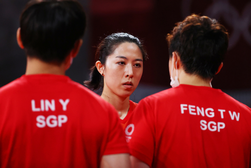 Yu Mengyu of Singapore with Lin Ye of Singapore and Feng Tianwei of Singapore during her match against Jia Nan Yuan of France, at the Tokyo Metropolitan Gymnasium, August 2, 2021. u00e2u20acu2022 Reuters picnn
