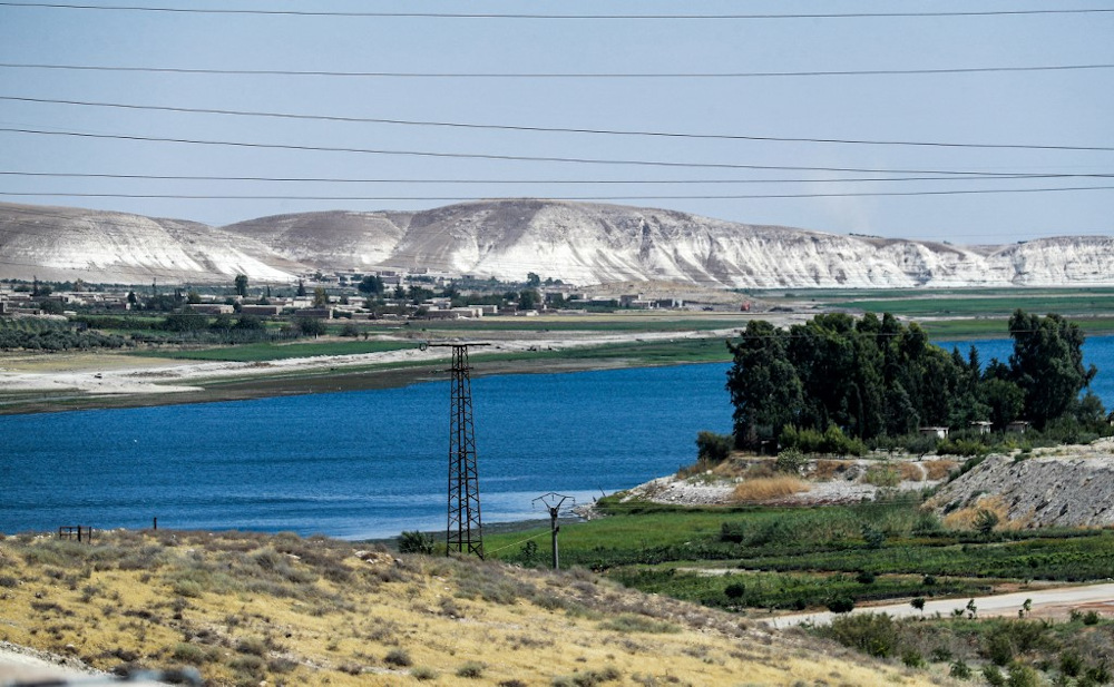 This picture taken on July 24, 2021 shows a view of the high voltage electricity transmission lines connecting to the 1999 Tishrin (October) Dam (unseen) along the Euphrates river near Manbij in eastern Syria. u00e2u20acu201d AFP pic
