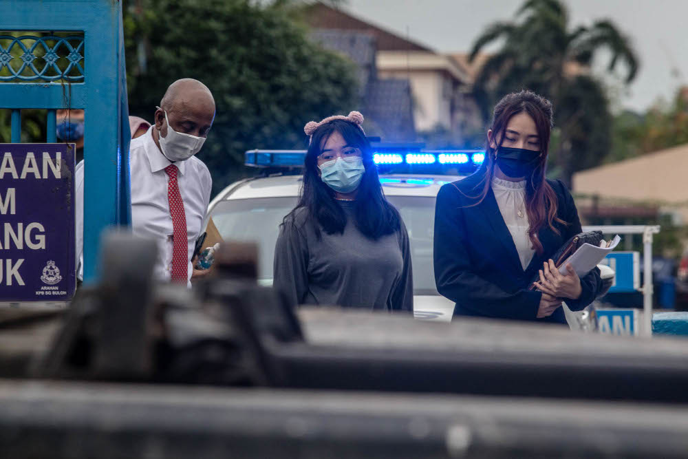 Student Ain Husniza Saiful Nizam and her lawyer Datuk David Sankara Nair leave after giving her statement to the police at IPD Sungai Buloh, August 6, 2021. u00e2u20acu2022 Picture by Firdaus Latif