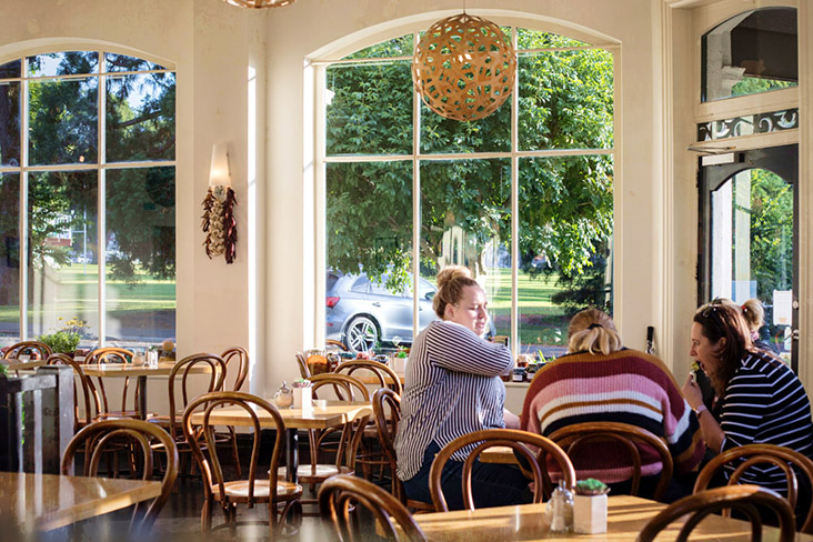 Table of diners at The Good Earth Café in Dunedin.