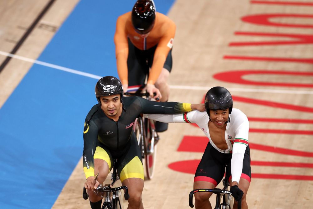 Mohd Azizulhasni Awang of Malaysia and Jair Tjon En Fa of Suriname react after the menu00e2u20acu2122s keirin final at the Izu Velodrome in Shizuoka August 8, 2021. u00e2u20acu201d Reuters pic