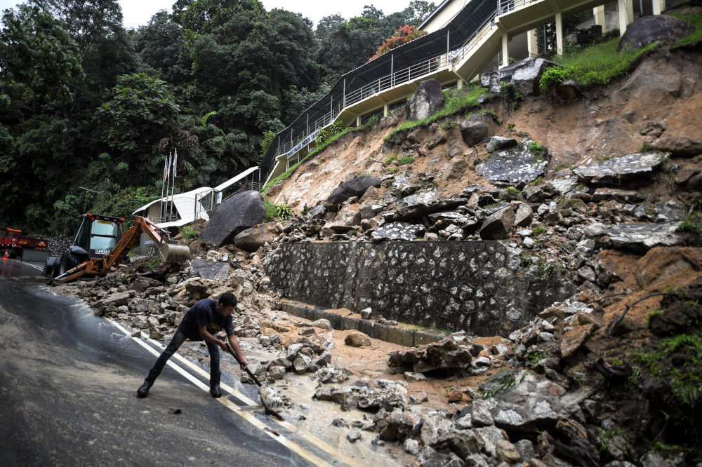 A worker cleans up debris from the slope near the Sheikh Tahir Astronomy Centre building in Jalan Pantai Acheh, August 16, 2021. u00e2u20acu201d Bernama pic 