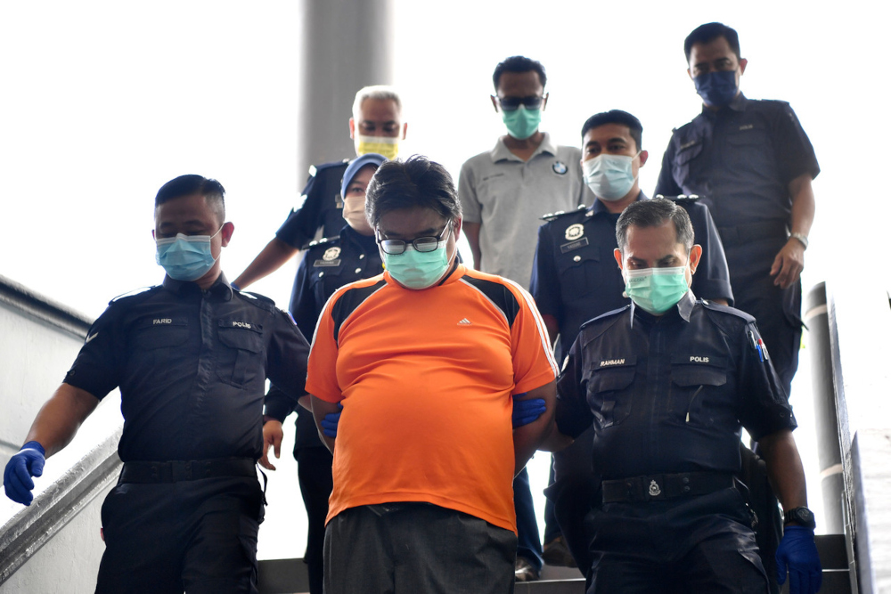Both the accused, Tuah Shah Abd Rahman (back, centre), 48, and Zainal Abu Bakar (front, centre), 48, pleaded not guilty to the charges before judge Nariman Badruddin. u00e2u20acu201d Bernama picn