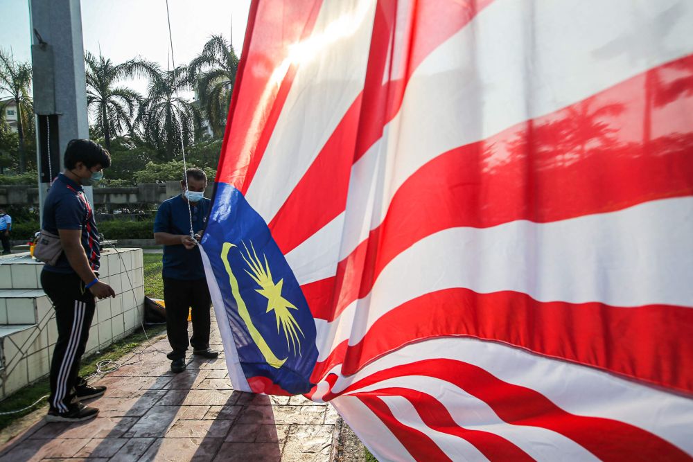 Ipoh City Council workers hang up the Jalur Gemilang at Dataran Ipoh August 13, 2021. u00e2u20acu201d Picture by Farhan Najib