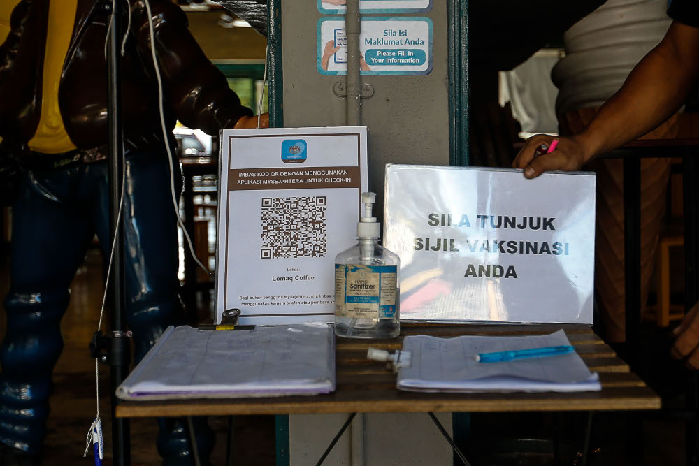 A sign requiring dine-in patrons to show their vaccination certificate Lomaq Coffee, Seberang Jaya, August 9, 2021. u00e2u20acu201d Picture by Sayuti Zainudin