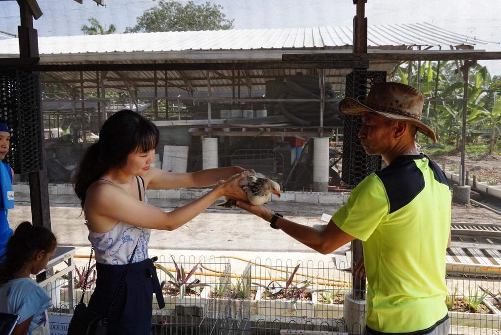 Eric Woo Yoke Meng (right) pictured giving advice on poultry in a photograph he supplied in 2019. u00e2u20acu201d Eric Woo pic via TODAY