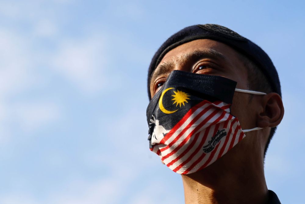 A police officer wearing a face mask featuring the Jalur Gemilang is seen in George Town August 26, 2021. u00e2u20acu201d Picture by Sayuti Zainudin