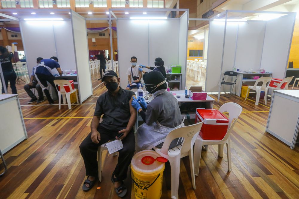 Foreign workers receive their Covid-19 jab during the Selangor Vaccination Programme at Pusat Kompleks Sukan PKNS in Kelana Jaya August 11, 2021. u00e2u20acu2022 Picture by Yusof Mat Isa