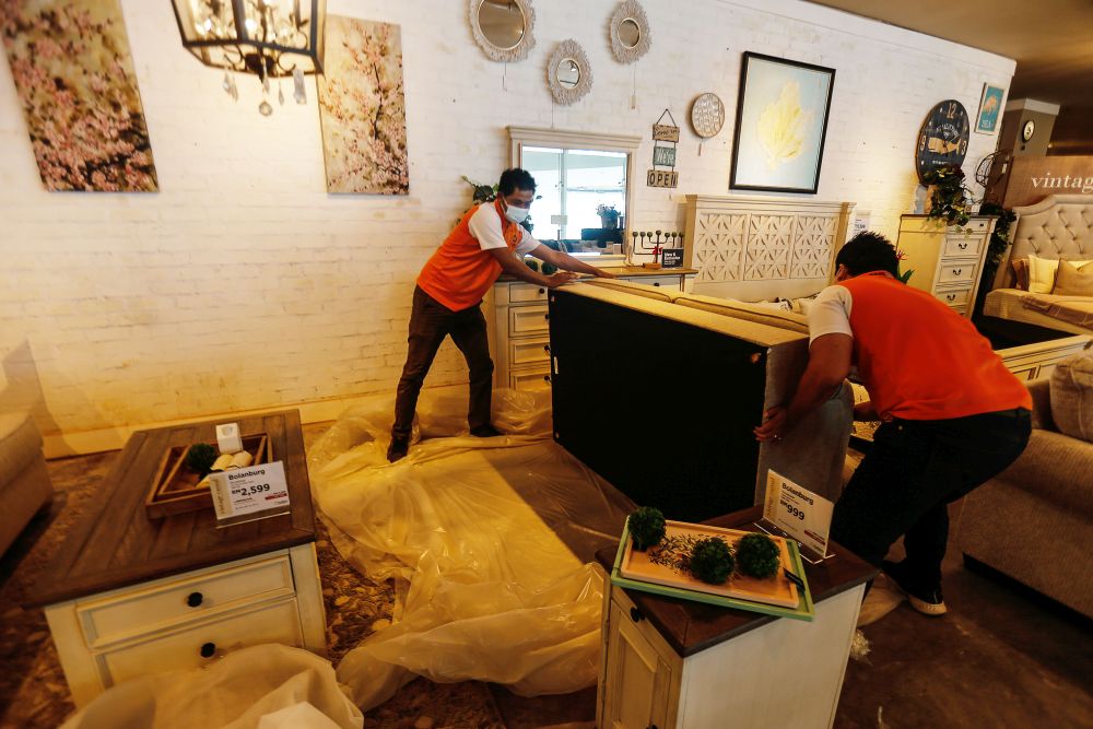 Workers at a furniture shop make preparations to reopen their store to shoppers at the Gurney Paragon Mall, George Town, August 18, 2021. ― Picture by Sayuti Zainudin