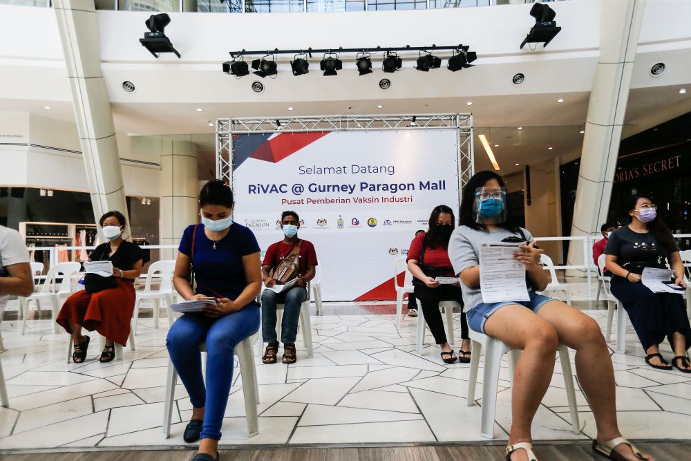 Penang retail workers wait to receive their Covid-19 jabs at the Gurney Paragon Mall in George Town August 17, 2021. u00e2u20acu201d Picture by Sayuti Zainudin