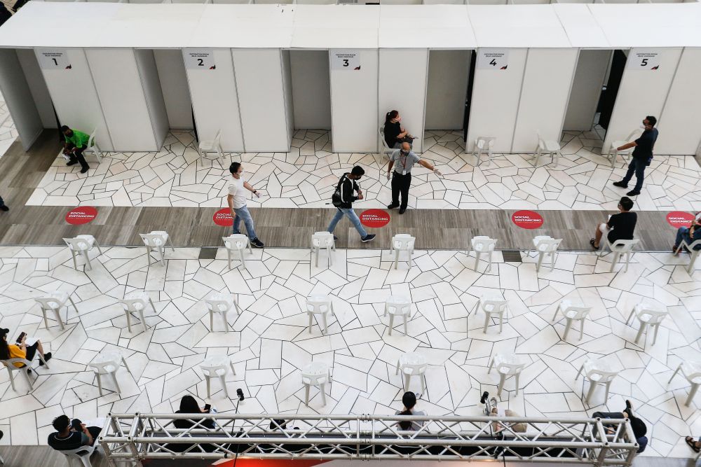 Penang retail workers wait to receive their Covid-19 jabs at the Gurney Paragon Mall in George Town August 17, 2021. u00e2u20acu201d Picture by Sayuti Zainudin