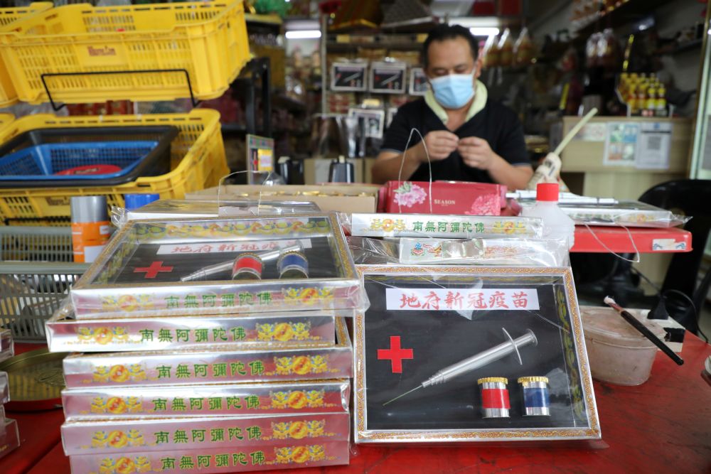 Prayer paraphernalia shop owner Raymond Shieh makes handmade paper vaccines at his shop in Johor Baru August 24, 2021. u00e2u20acu201d Reuters pic