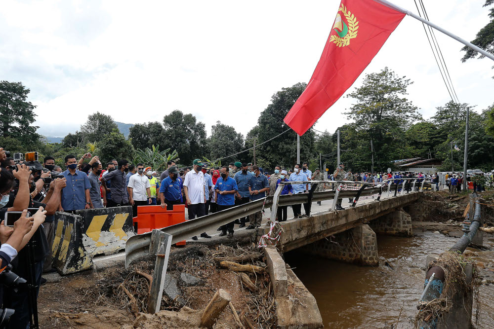Datuk Seri Ismail Sabri Yaakob with Kedah Mentri Besar Muhammad Sanusi Md Nor looking at the damaged area due to the water spout occurrence in Jambatan Tupah, Sungai Petani, Kedah, August 23, 2021. u00e2u20acu201d Picture by Sayuti Zainudin
