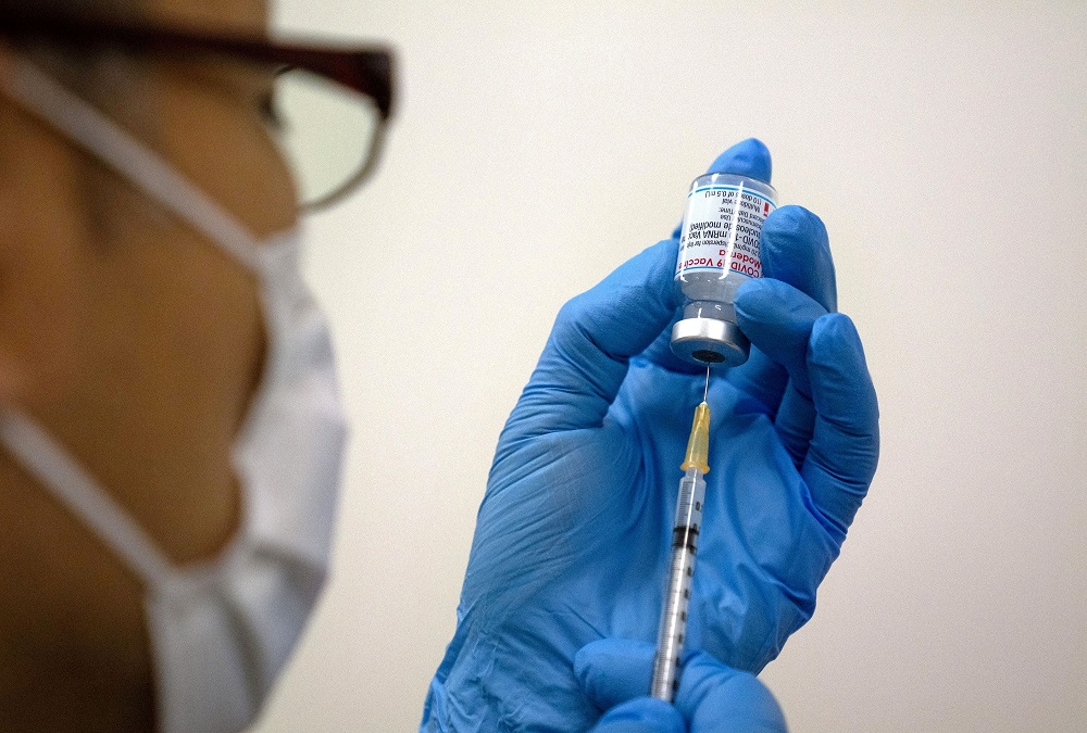 File picture of medical staff preparing the Moderna vaccine to be administered at the newly-opened mass vaccination centre in Tokyo, Japan May 24, 2021. u00e2u20acu2022 Carl Court/Pool via Reuters