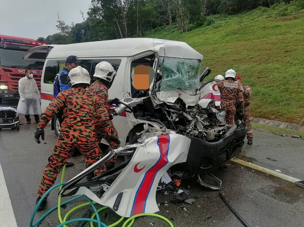 Firemen extracting the victims from a Health Ministry ambulance after it was involved in an accident along Kilometre 9.7 of the North-South Expressway near Johor Baru, August 18, 2021 u00e2u20acu201d Picture courtesy of the Johor Fire and Rescue Department