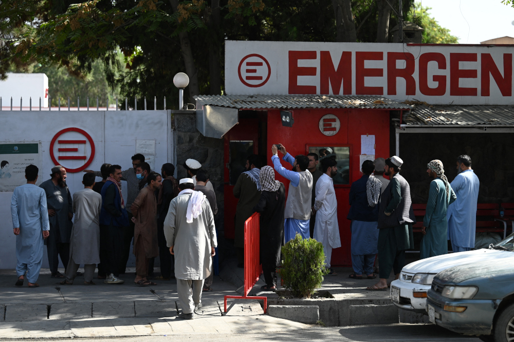 People gather to check on missing relatives a day after a twin suicide bombs attack, which killed scores of people including 13 US troops outside Kabul airport, at a hospital run by Italian NGO Emergency in Kabul, August 27, 2021. u00e2u20acu201d AFP pic 