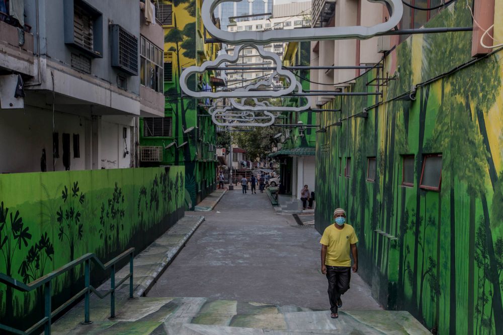 People wearing face masks walk on a street in Kuala Lumpur August 13, 2021. u00e2u20acu201d Picture by Firdaus Latif