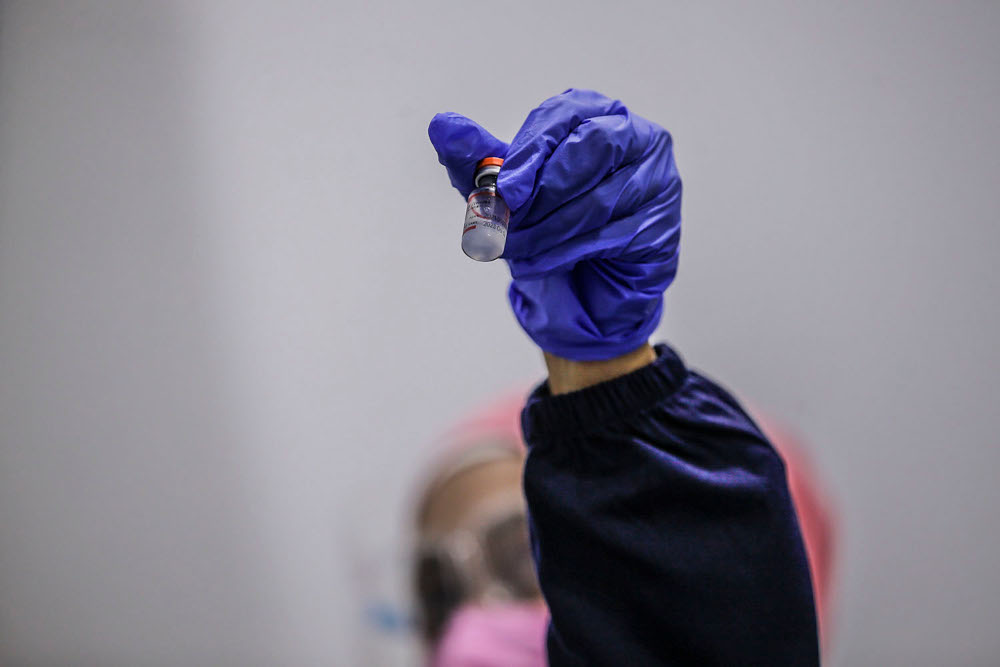 A health personnel show a vial of Covid-19 vaccine at the Kuala Lumpur Convention Centre vaccination centre, August 2, 2021. u00e2u20acu2022 Picture by Hari Anggara