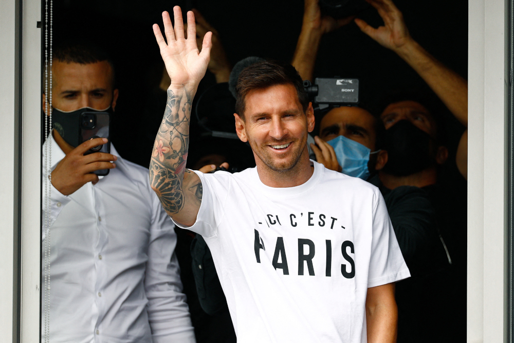 Argentinian football player Lionel Messi waves to supporters from a window after he landed August 10, 2021 at Le Bourget airport, north of Paris. u00e2u20acu2022 AFP pic 