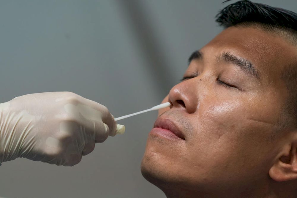 A man undergoing a swab test. From Oct 1, 2021, non-vaccinated workers from selected sectors will be required to undergo regular testing to pick up possible infections early, so that they can be treated early, the Ministry of Health said. u00e2u20acu201d AFP pic