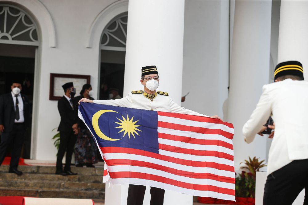 Air Putih assemblyman Lim Guan Eng poses for the cameras as he holds aloft the Jalur Gemilang at the Penang state assembly building in George Town August 30, 2021. u00e2u20acu201d Picture by Sayuti Zainudin