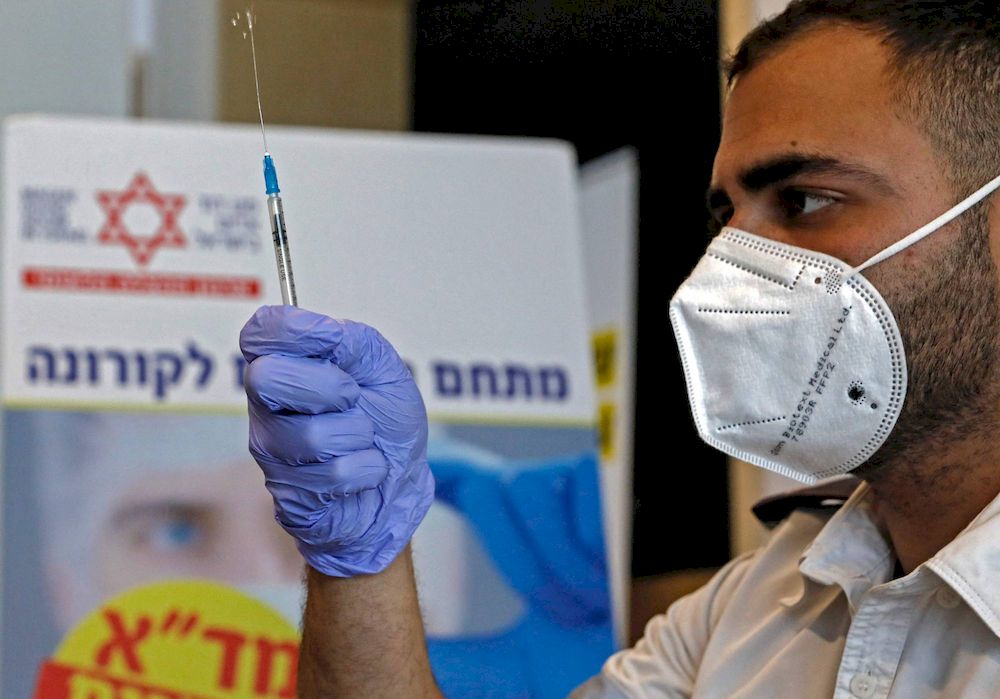 A paramedic prepares a dose of the Pfizer-BioNtech Covid-19 vaccine in Beit Shemesh, Israel. u00e2u20acu201d AFP pic