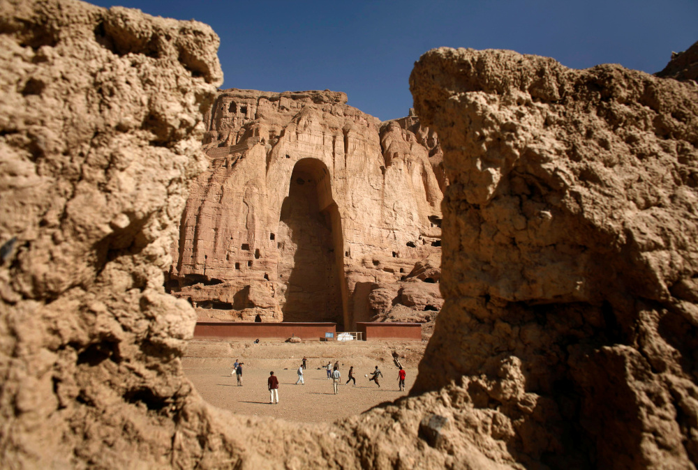 Afghan boys play football in front of the gaping niche where a giant Buddha statue used to stand in the central town of Bamiyan April 13, 2007. The Taliban destroyed two of the statues in 2001. u00e2u20acu201d Reuters pic