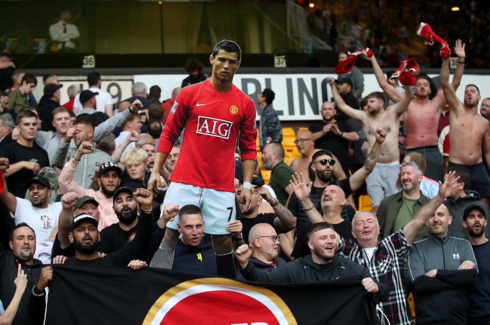 Manchester United fans celebrate with a cardboard cutout of Cristiano Ronaldo after the Wolverhampton Wanderers v Manchester United match at Molineux Stadium, Wolverhampton, Britain, August 29, 2021. u00e2u20acu201d Action Images pic via Reuters 