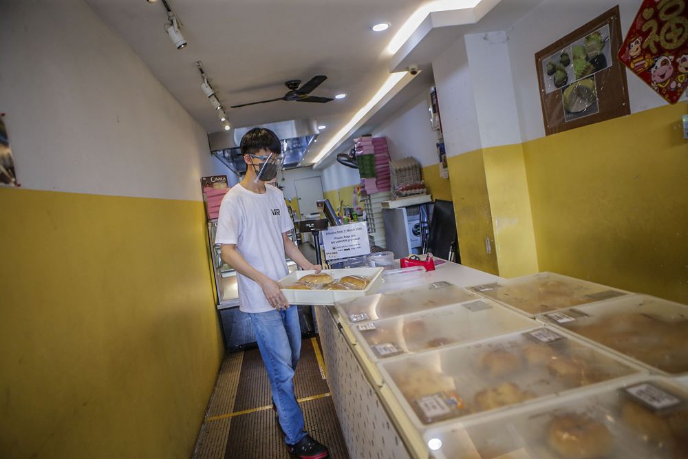 Sim Ming Zhen is seen at work at a bakery in Taman Desa, Kuala Lumpur August 11, 2021. 