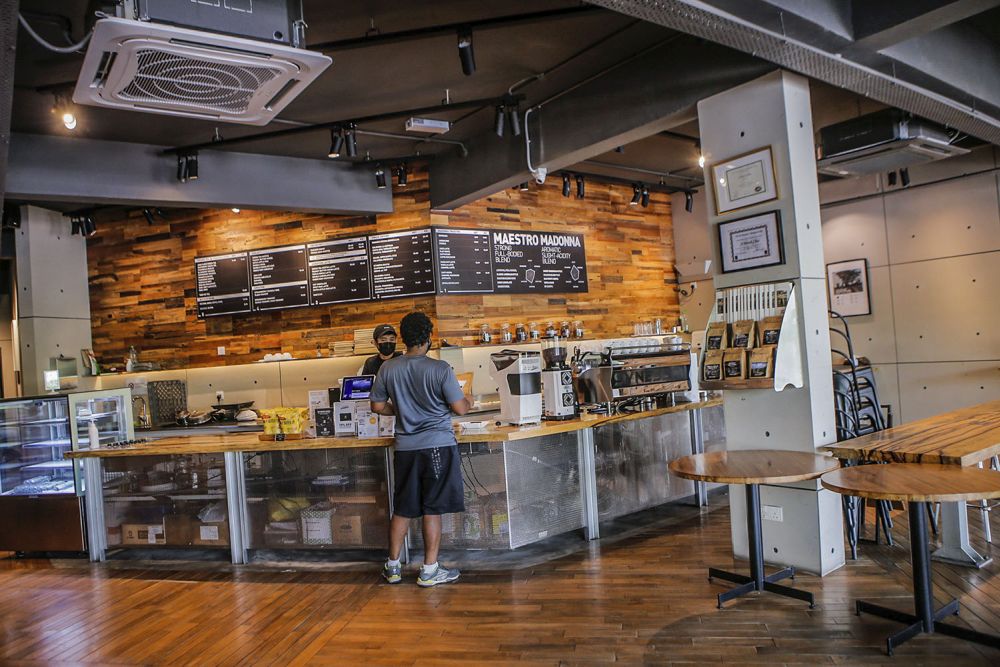 A patron orders a beverage at Coffea Coffee in Taman Danau Desa, Kuala Lumpur August 11, 2021. 