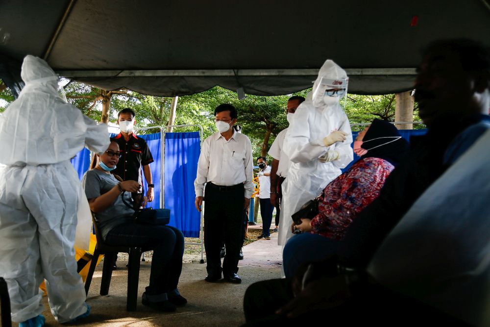 Penang Chief Minister Chow Kon Yeow (centre) is pictured during a visit to the mass screening exercise in Taman Manggis, George Town August 12, 2021. u00e2u20acu201d Picture by Sayuti Zainudin