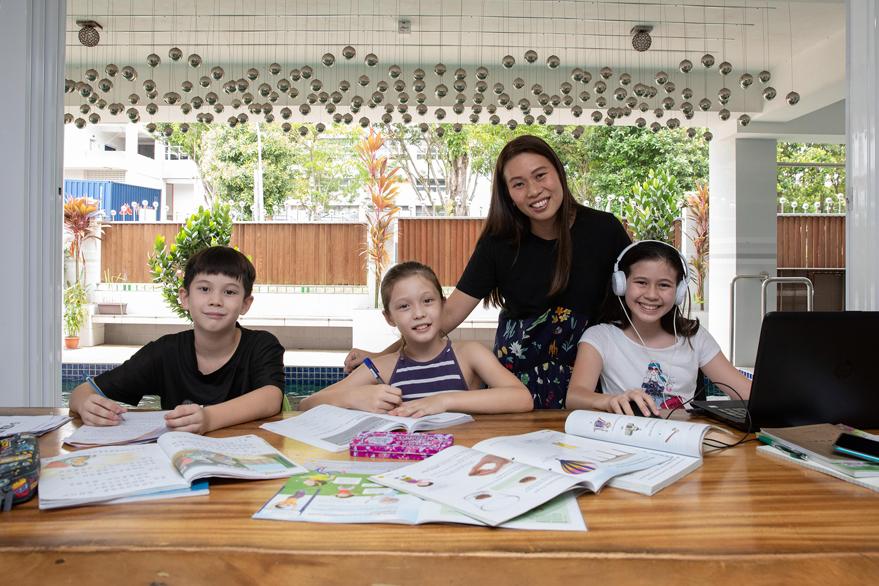 Housewife Iris Sim, 40, and her husband spend just over S$2,000 a month on tuition and enrichment classes for his three children — (L-R) Cameron James Glasscoe, 8, Aurelia Dawn Glasscoe, 9, and Summer Rose Glasscoe, 11.
