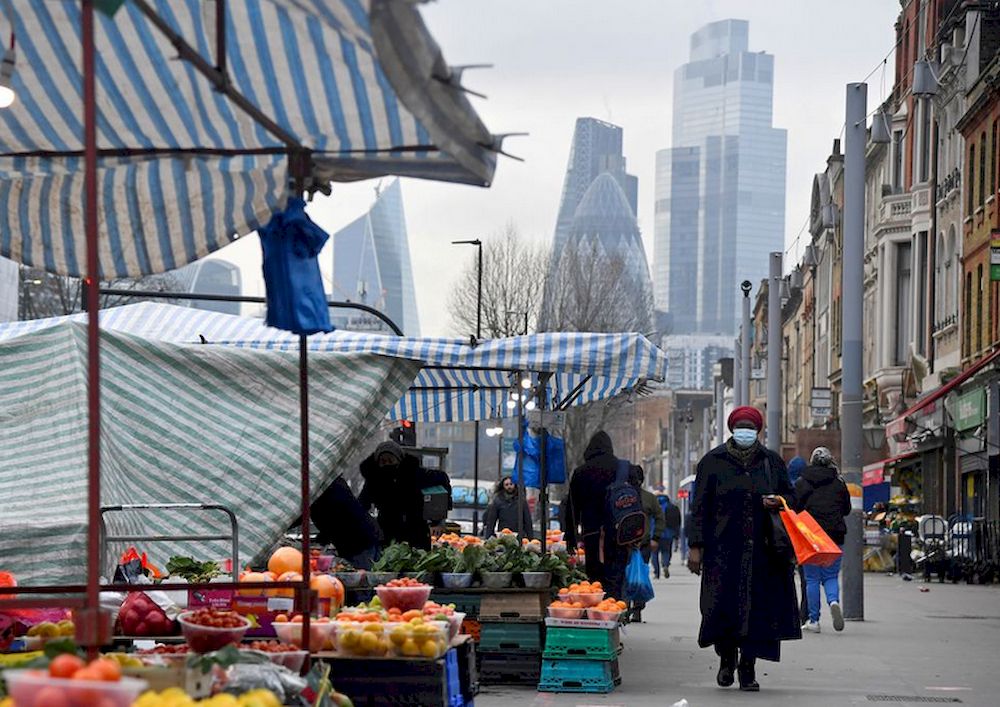 People shop at market stalls, with skyscrapers of the City of London financial district seen behind, amid the coronavirus disease (Covid-19) pandemic, in London, Britain, January 15, 2021. u00e2u20acu201d Reuters pic