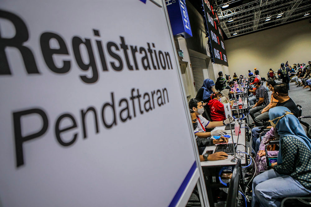 Walk-in vaccine recipients during registration for their Covid-19 jabs at the Kuala Lumpur Convention Centre vaccination centre, August 2, 2021. u00e2u20acu2022 Picture by Hari Anggara