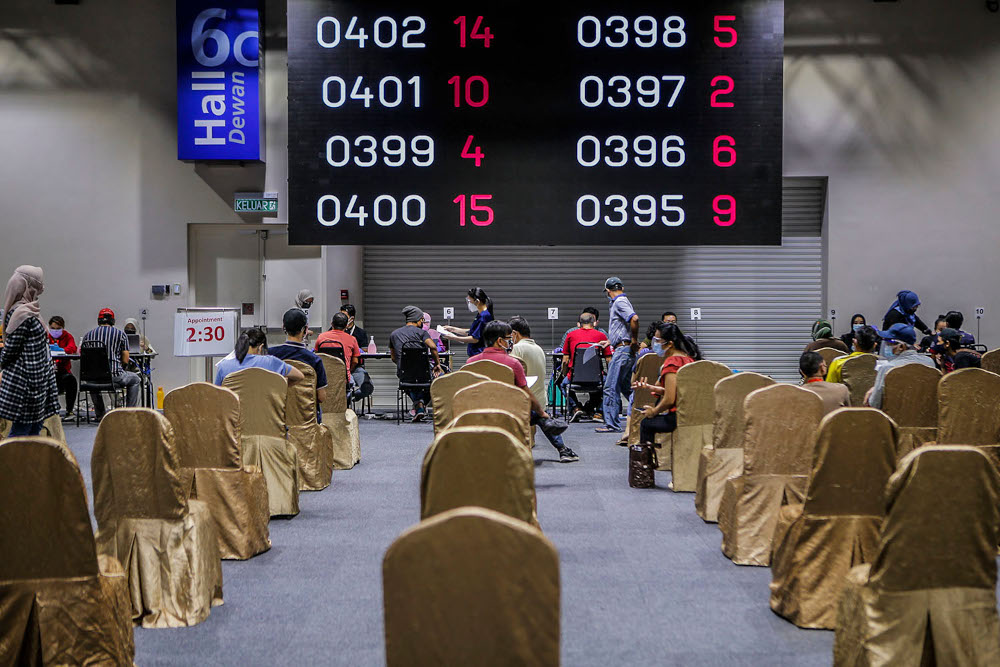 Walk-in vaccine recipients wait for their number to be called up for their Covid-19 jabs at the Kuala Lumpur Convention Centre vaccination centre, August 2, 2021. u00e2u20acu2022 Picture by Hari Anggara