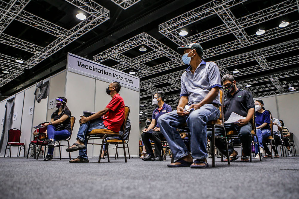 Walk-in recipients wait to get their Covid-19 vaccine injection at the Kuala Lumpur Convention Centre vaccination centre, August 2, 2021. u00e2u20acu2022 Picture by Hari Anggara