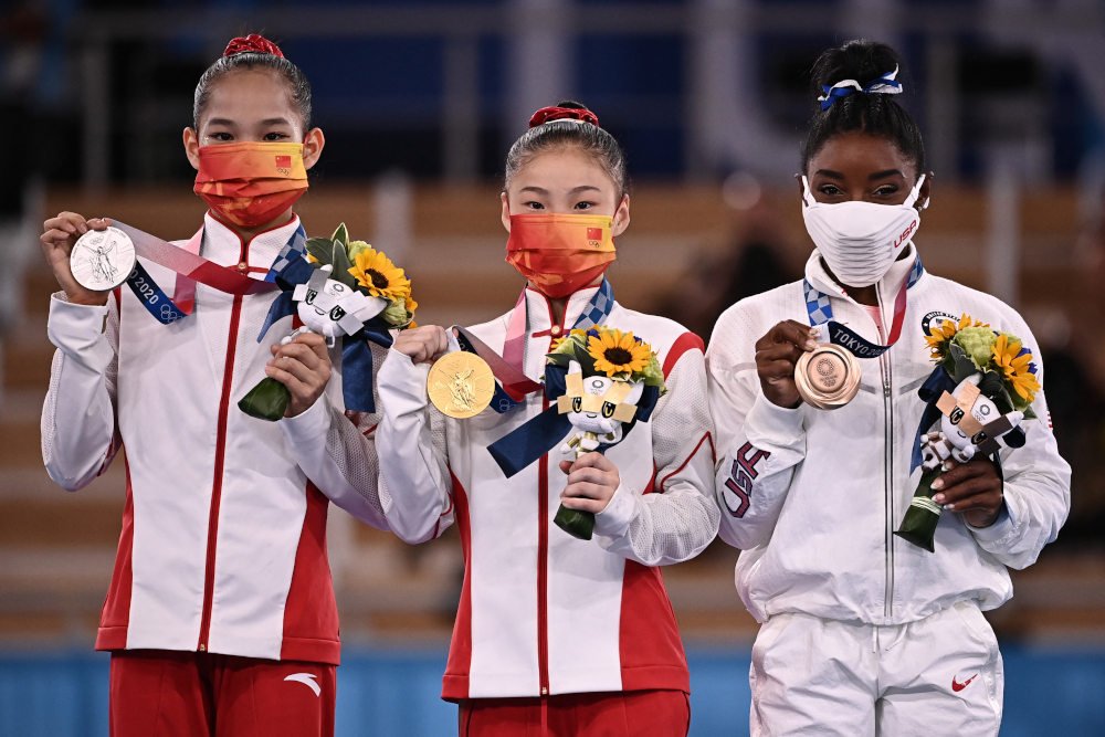 (From left) Chinau00e2u20acu2122s Xijing Tang (silver) Chinau00e2u20acu2122s Chenchen Guan (gold) and USAu00e2u20acu2122s Simone Biles (bronze) during the medal ceremony of the artistic gymnastics womenu00e2u20acu2122s balance beam at Ariake Gymnastics Centre in Tokyo August 3, 2021. u00e2u20acu2022 AFP pic
