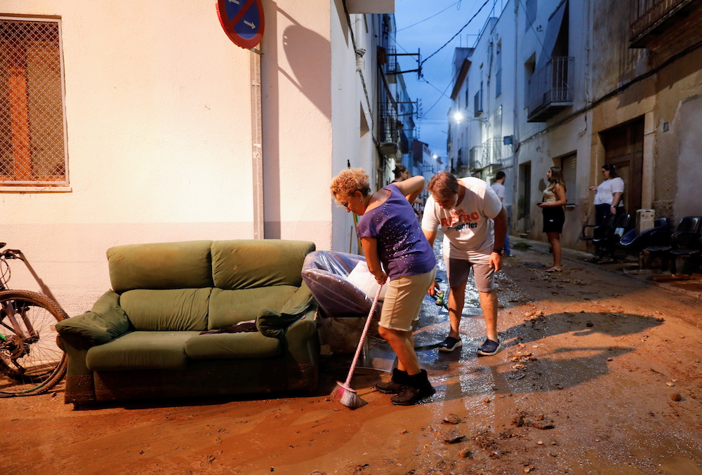 People clean the mud of a street after floods caused by heavy rains in Alcanar, Spain September 1, 2021. u00e2u20acu201d Reuters pic