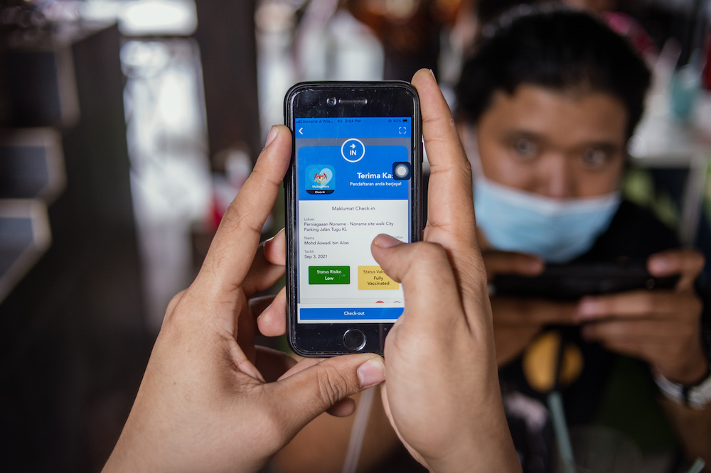 The MySejahtera app has been updated to make it easier for people to display their risk level and vaccination status. u00e2u20acu201d Picture by Shafwan Zaidon