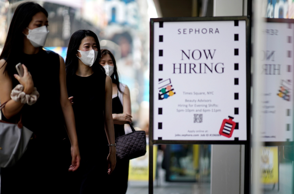 A sign advertising job openings is seen while people walk into the store in New York City, New York, US August 6, 2021. u00e2u20acu201d Reuters pic